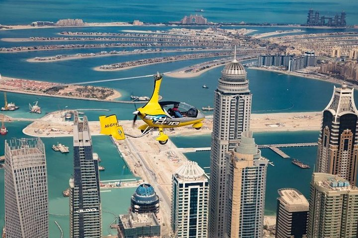 Soar high above Dubai taking in breathtaking views of iconic landmarks like Palm Jumeirah and Burj Al Arab creating picture-perfect memories from a unique perspective.